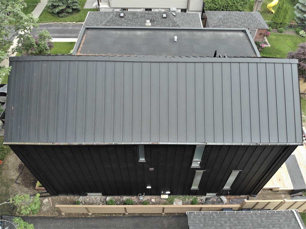 Black standing seam metal roof and facade