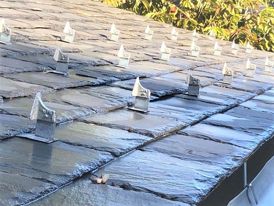 Stainless snow guards on slate roof