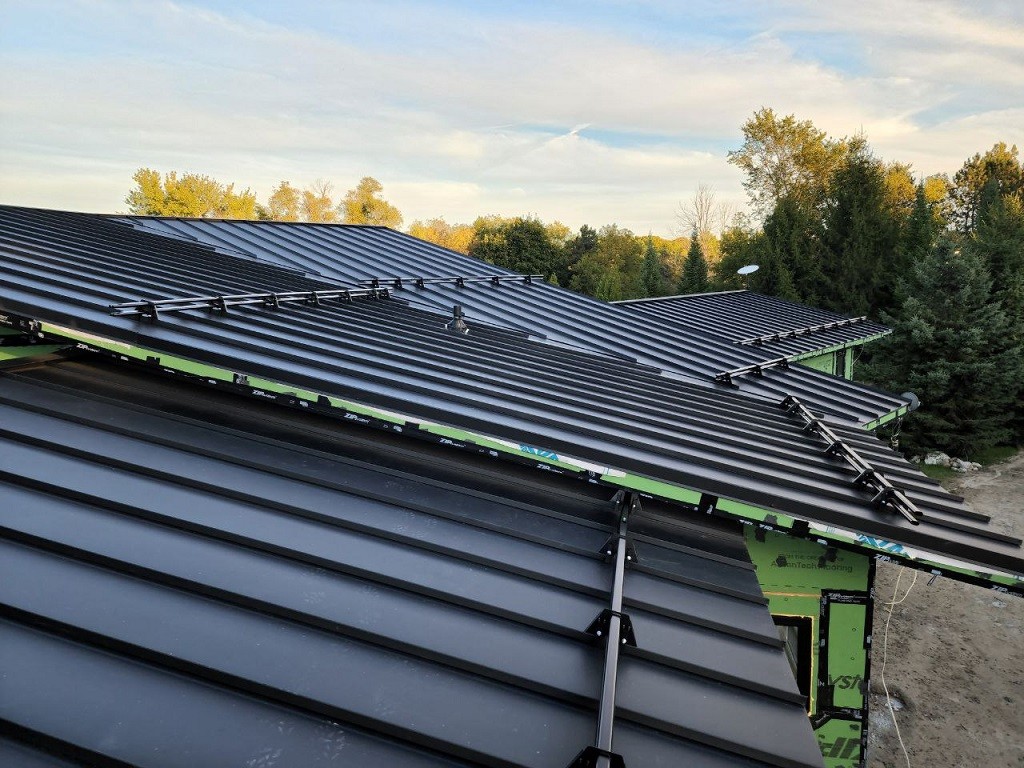 Steel snow guards for standing seam metal roof