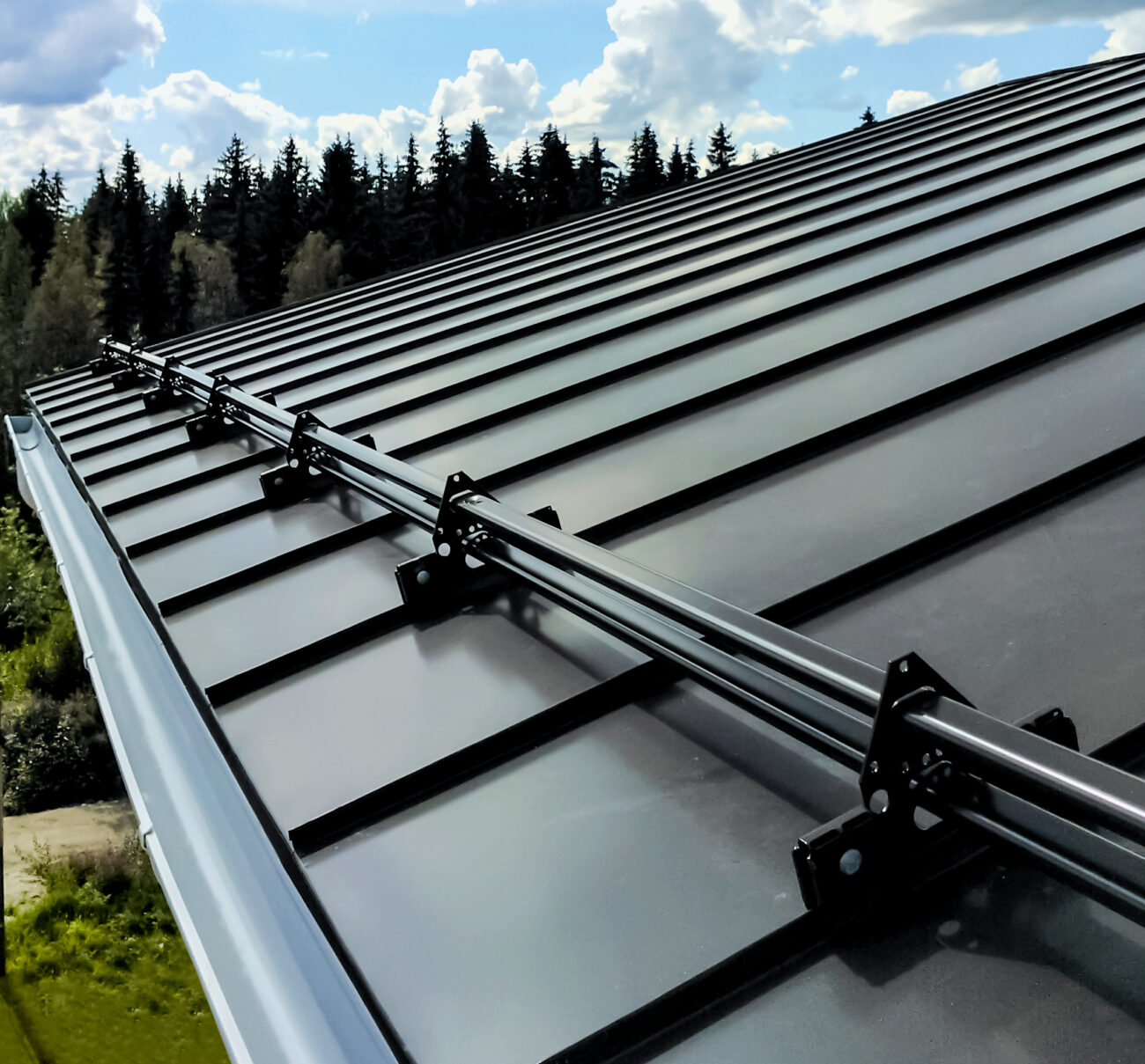 Mechanical lock standing seam profile with ORIMA snow guards, close-up view of concealed seam and clamp