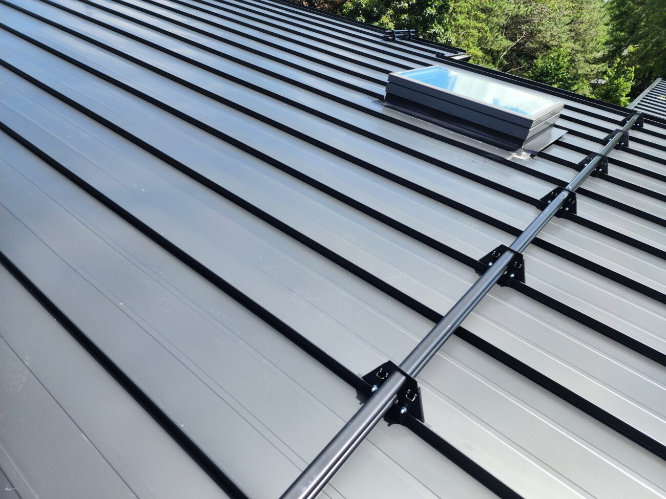 ORIMA tubular snow guards installed on standing seam metal roof in Aurora, Ontario