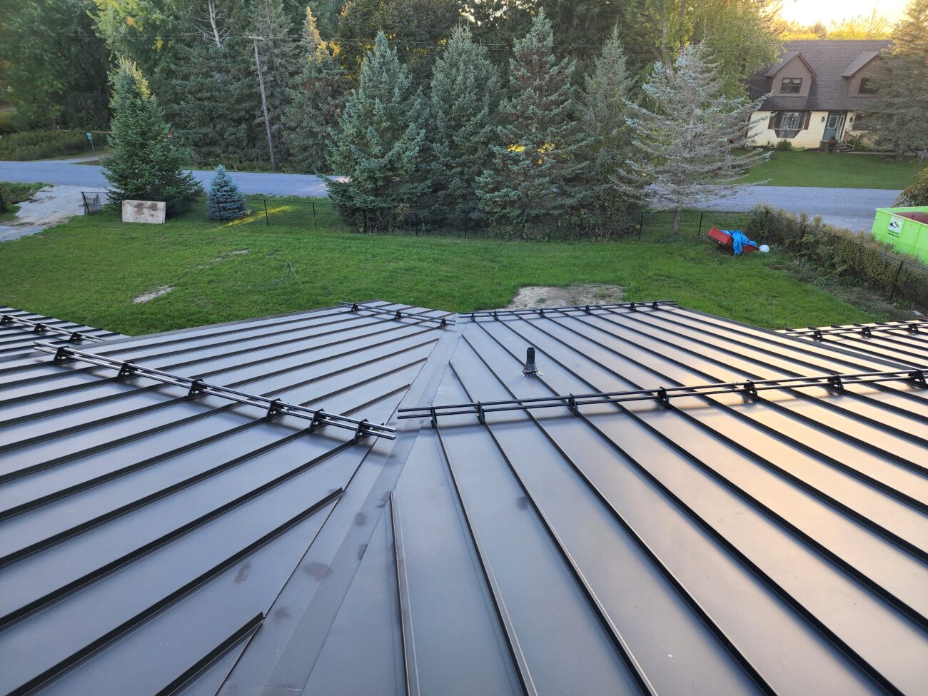 ORIMA tubular snow guards installed on standing seam metal roof in Barrie, Ontario