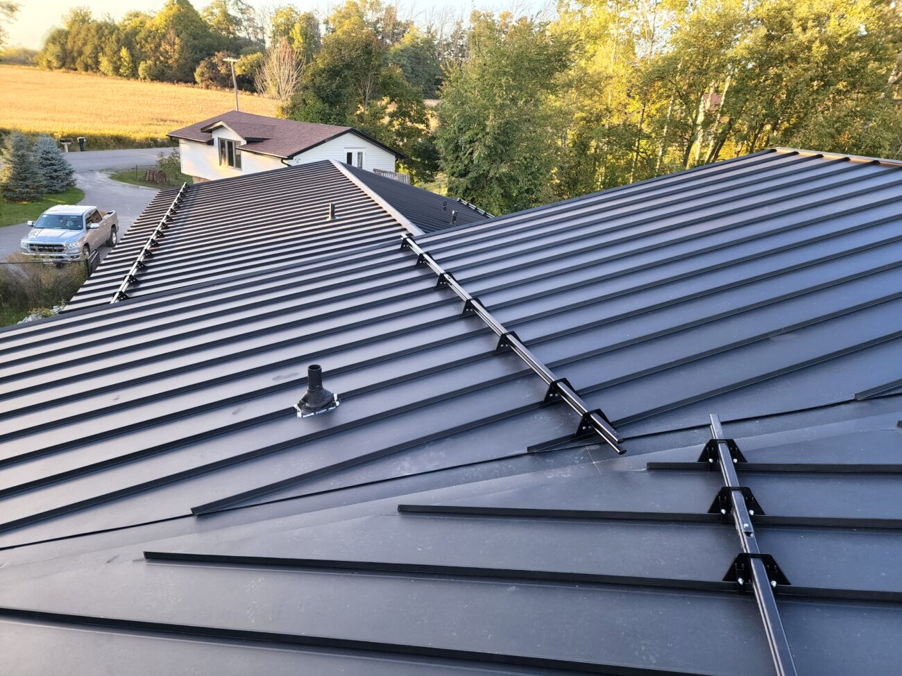 Snow guard row on standing seam metal roof close-up, Barrie Ontario