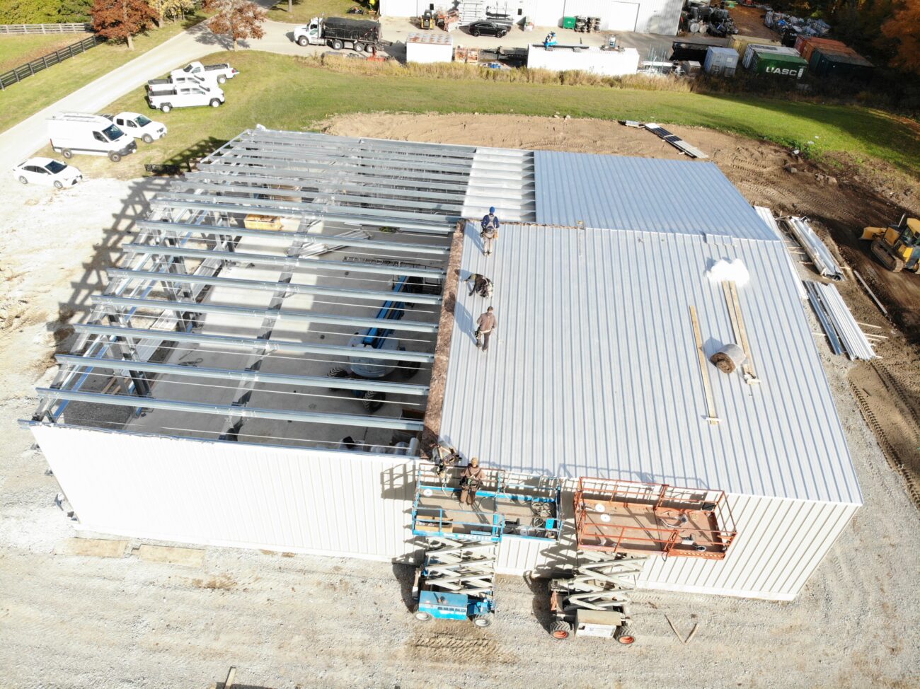 Pre-engineered metal building assembly in progress, Caledon, Ontario — aerial view of steel frame and roof installation