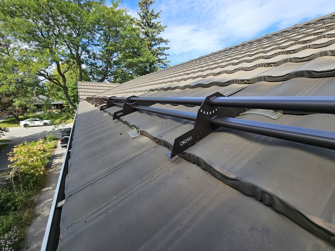 ORIMA LE3 tubular snow guards installed on metal tile roof, Uxbridge Ontario