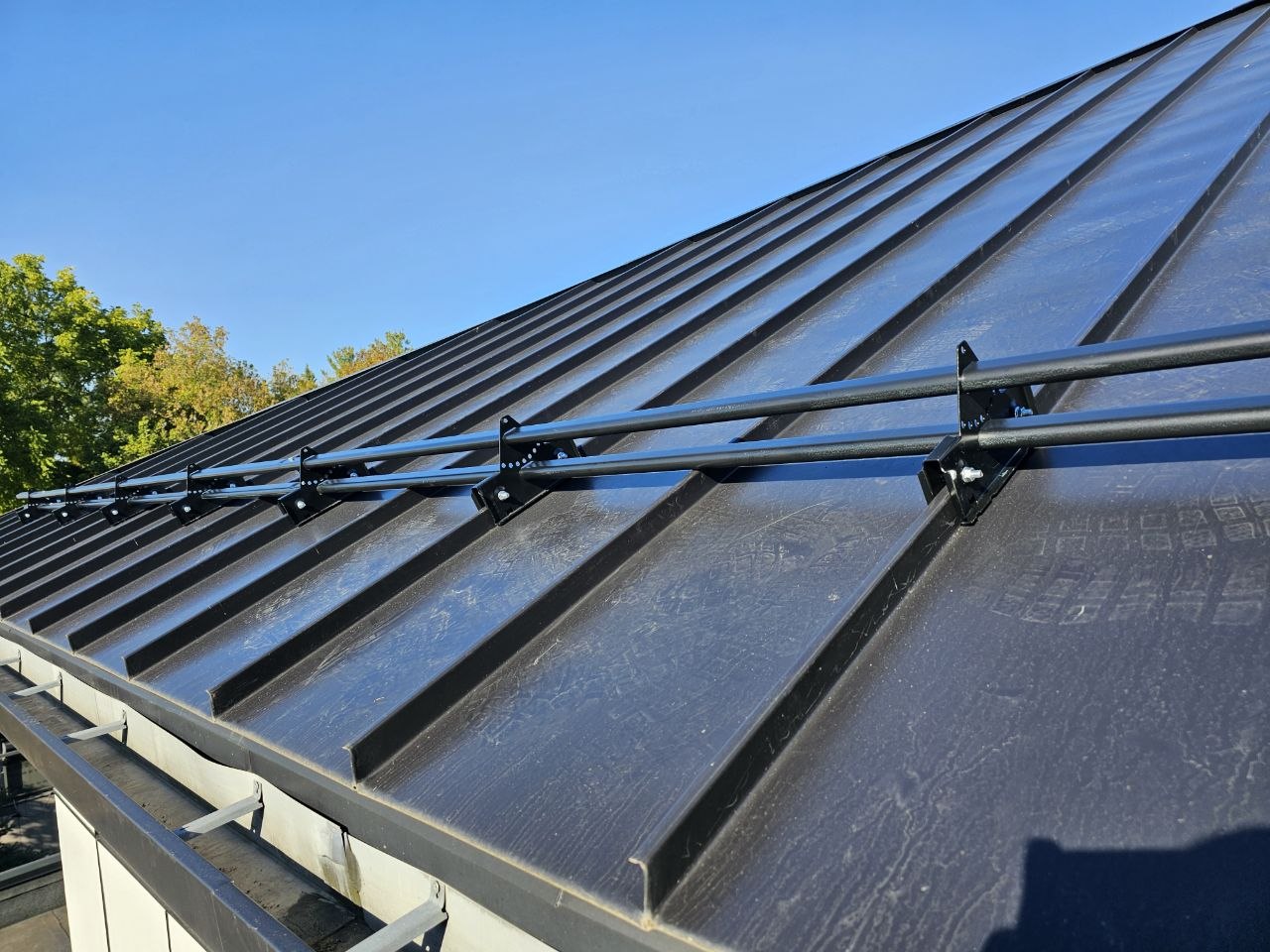 ORIMA LE2 snow guards installed on black mechanical lock standing seam roof, King City Ontario