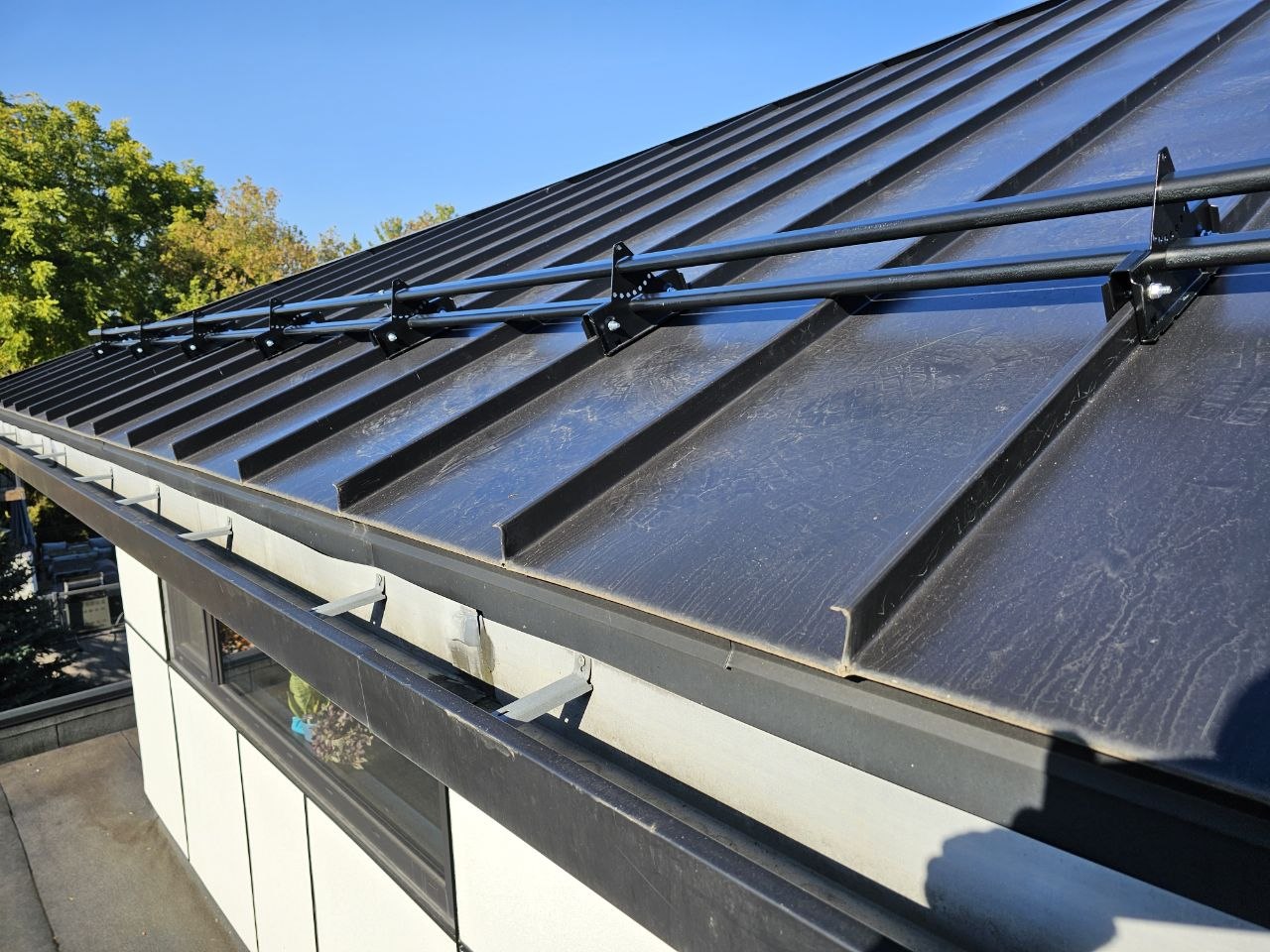 ORIMA LE2 snow guard row on black standing seam roof, King City Ontario