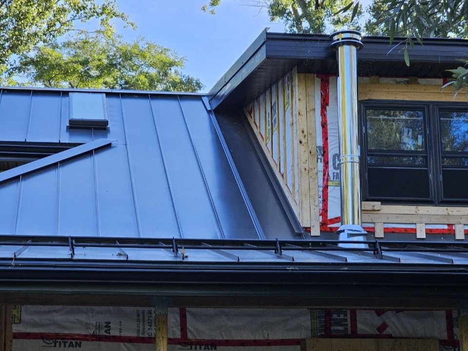 Steel tubular snow guards installed on snap-lock standing seam roof in Milton, Ontario