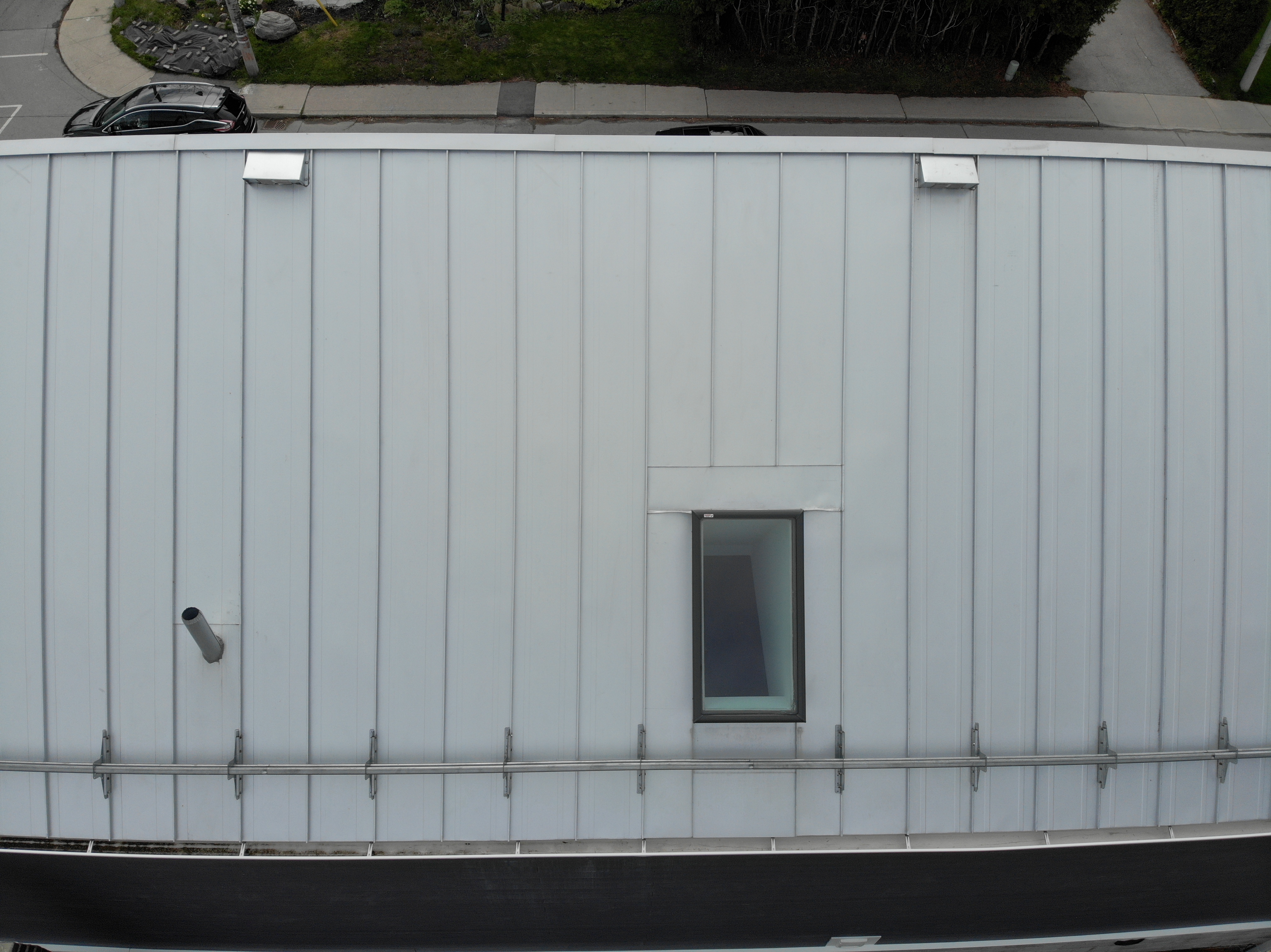 Steel tubular snow guards installed on Galvalume mechanical lock standing seam roof, North York Toronto