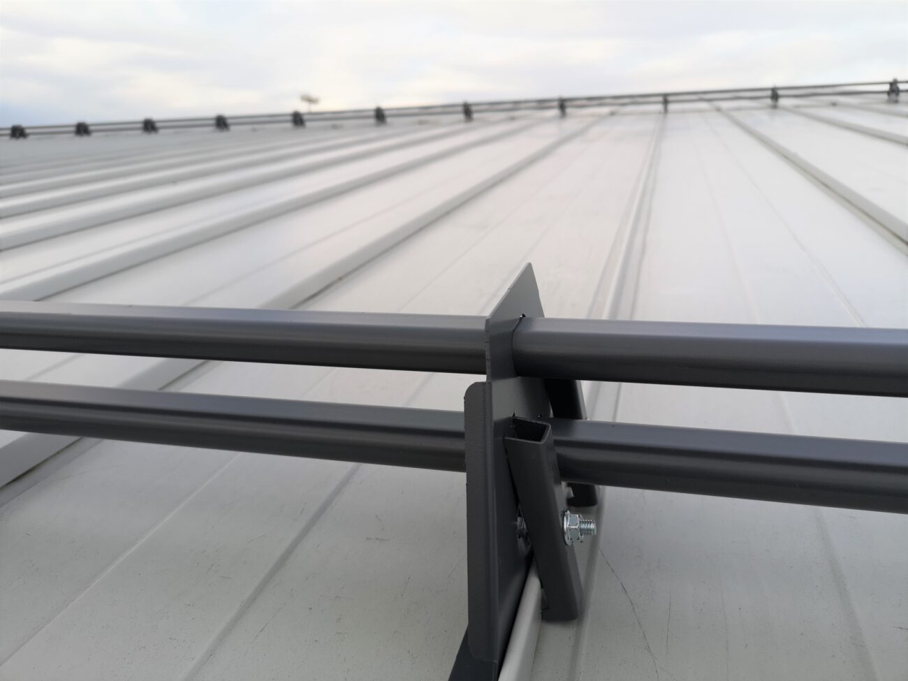 Two rows of steel tubular snow guards on snap-lock standing seam commercial roof, Vaughan Ontario