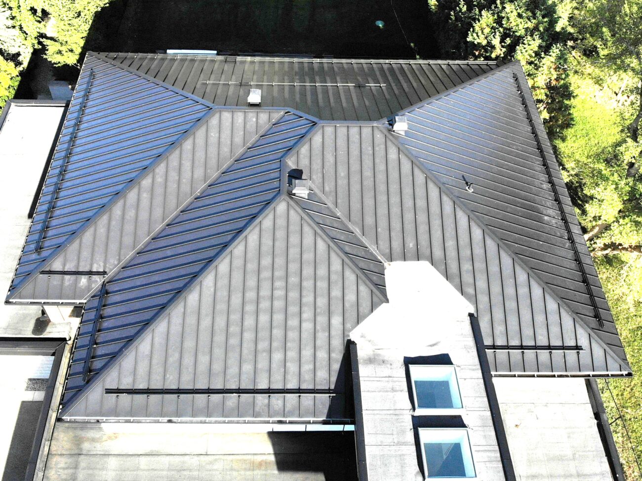Standing seam metal roof view showing roof slopes above terrace and parking area, King City Ontario