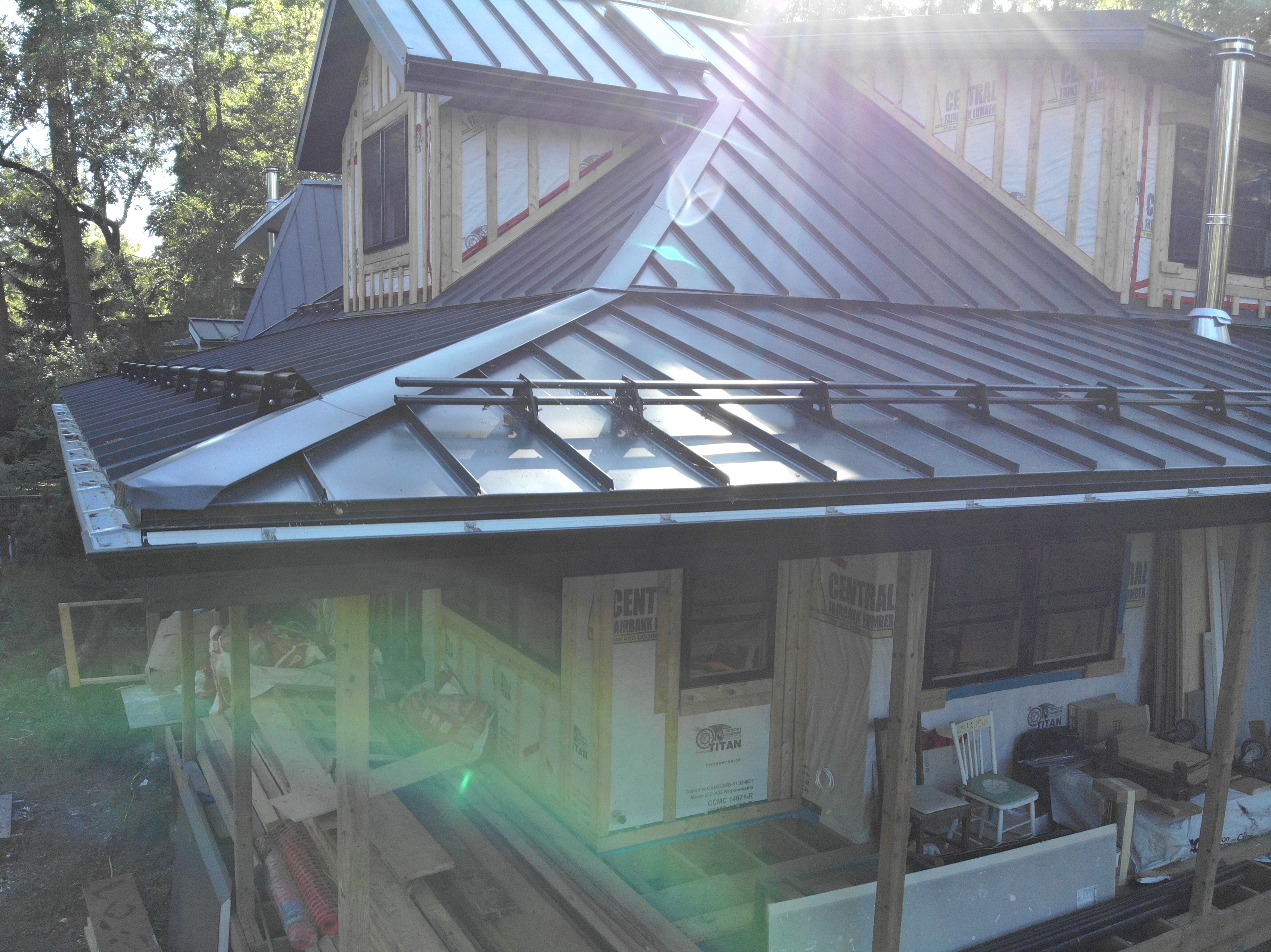 Snap-lock standing seam metal roof in black on residential property in Milton, Ontario