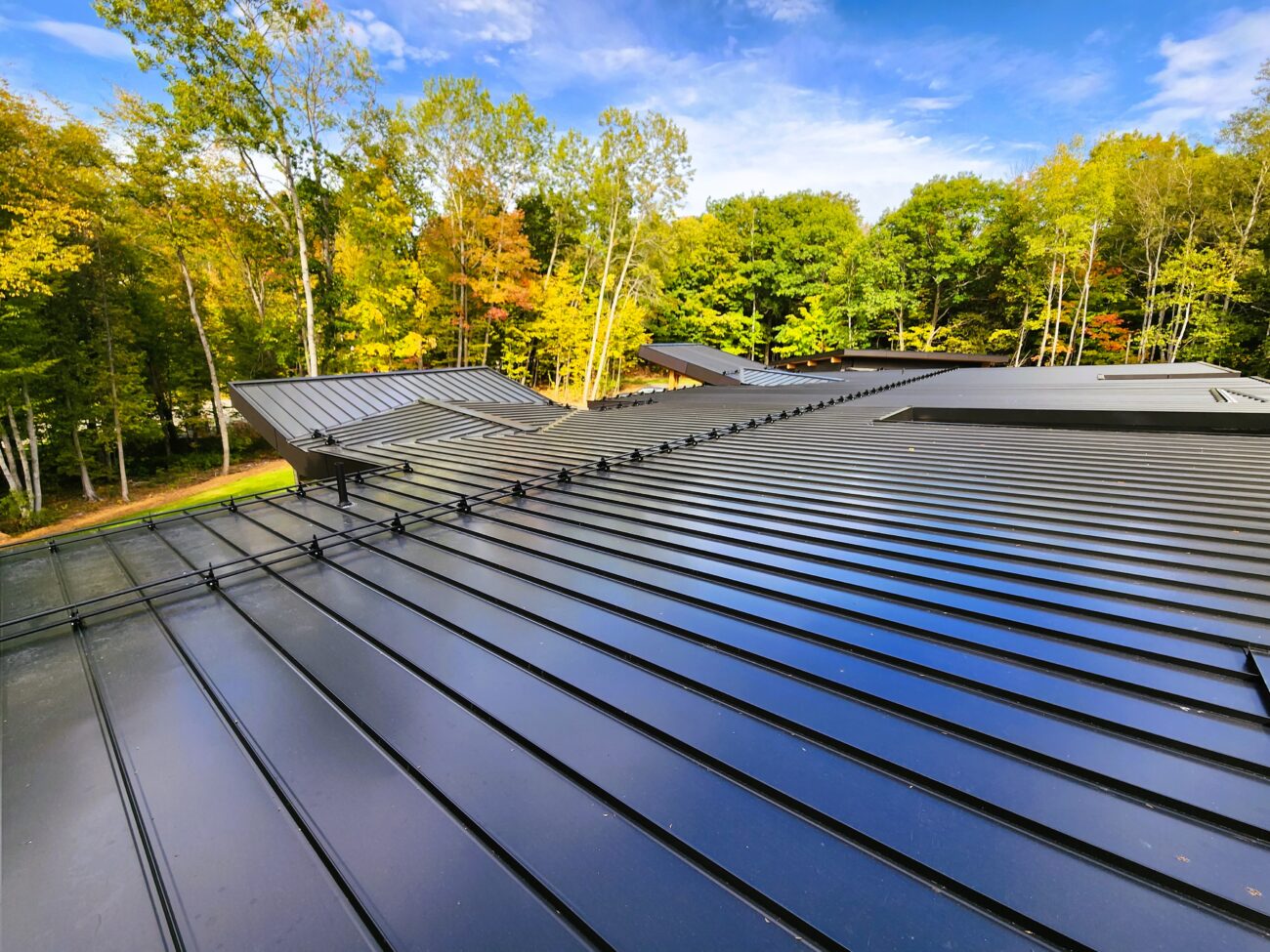 Black snap-lock standing seam roof full view on Muskoka cottage, Ontario